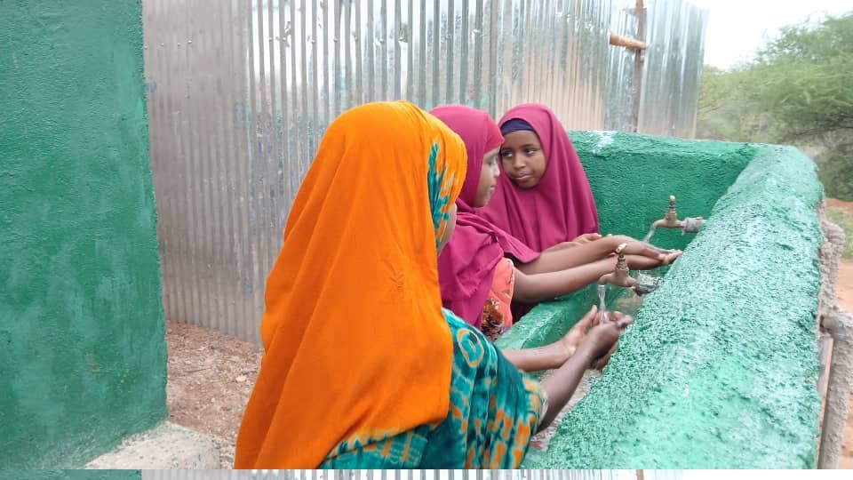 Girls using clean water tap